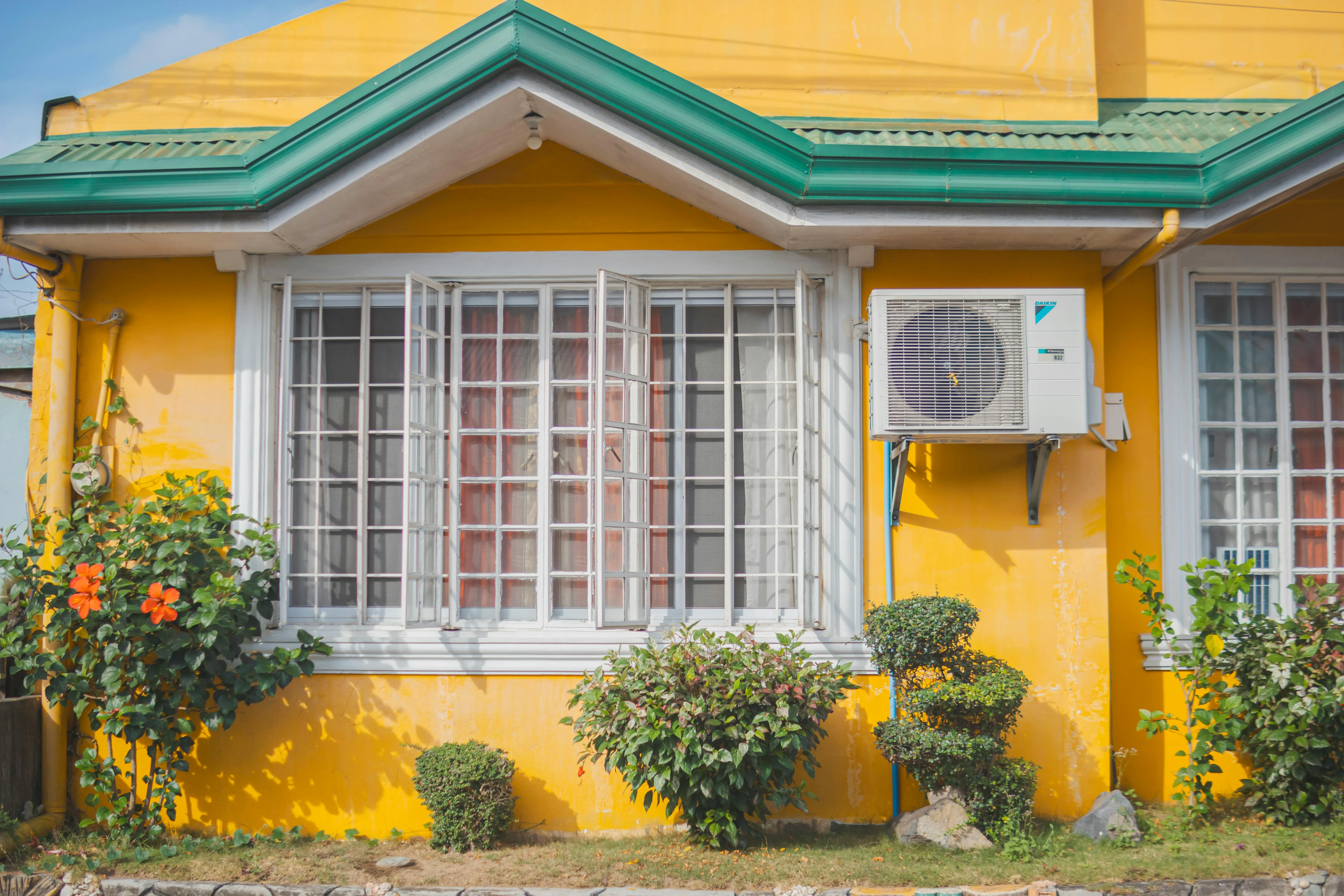 An air-source heating unit mounted to the exterior of a building — SCOP measures performance over a full heating season